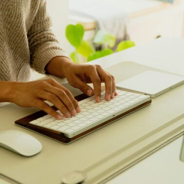 women typing on a computer doing a work at home job