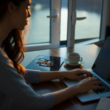 Women sitting in front of laptop blogging